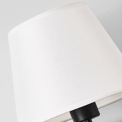 Close view of the woven white fabric shade and black lamp holder