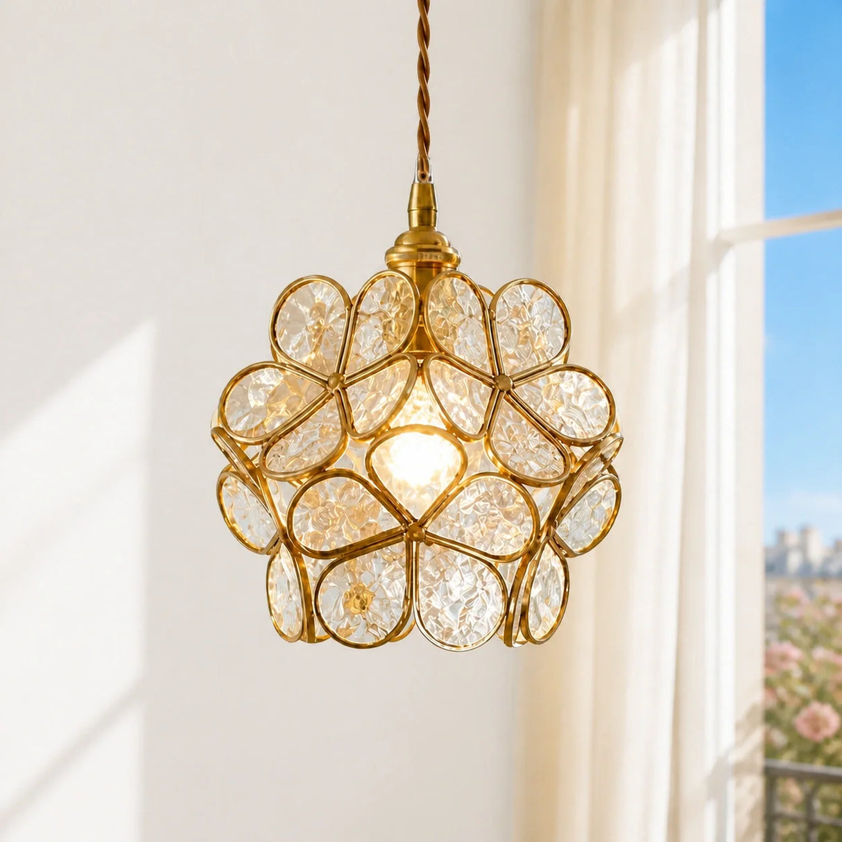 Full studio view of the transparent petal glass pendant light with brass cage