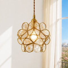 Full studio view of the transparent petal glass pendant light with brass cage