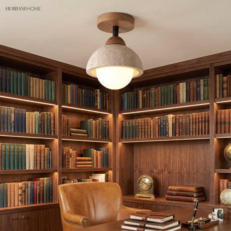 Stone dome semi flush ceiling light over a study with lit bookshelves