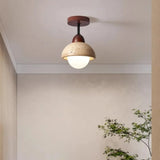 Travertine dome ceiling light lit against a ceiling