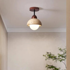 Travertine dome ceiling light lit against a ceiling