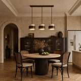Beige stone pendant light, three-head round plate, over a dining room table