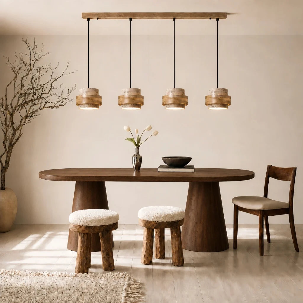Beige travertine pendant light, four heads, above an oval dining table