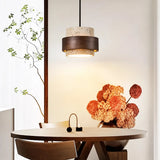 Beige travertine pendant light with dark wood band, single head, round table