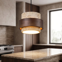Travertine and wood pendant light hanging above a stone kitchen island