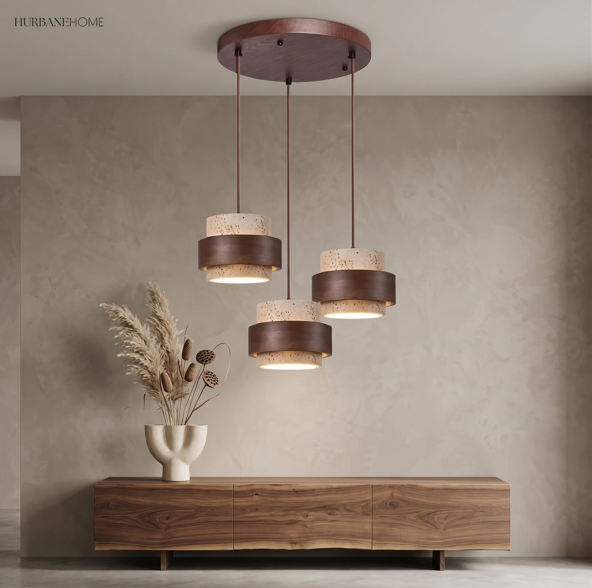 Round canopy cluster of three travertine pendants over a living room sideboard