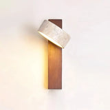 Detail view of the travertine wall sconce shade and slim wood mounting arm