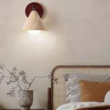 Travertine wall sconce shade seen from below with lit globe