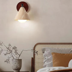 Travertine wall sconce shade seen from below with lit globe