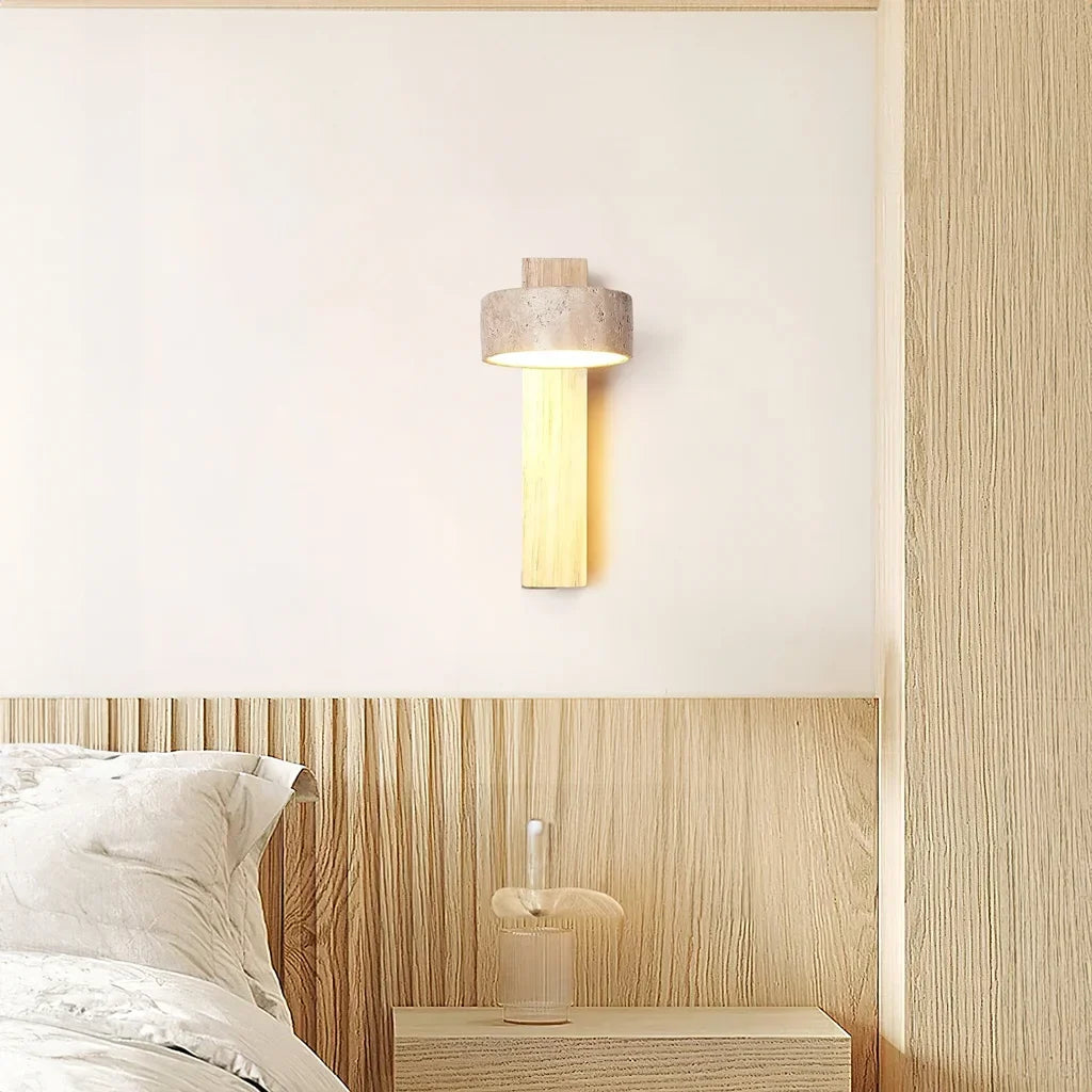 Travertine wall sconce washing a soft warm glow across a minimalist wall