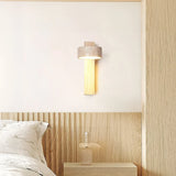Travertine wall sconce washing a soft warm glow across a minimalist wall