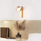 Travertine and wood wall sconce mounted above a neutral upholstered sofa