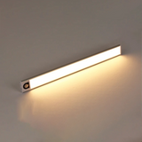 Silver light bar lit warm white on a plain background