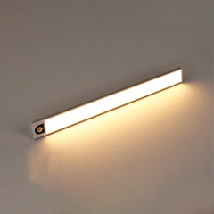 Silver light bar lit warm white on a plain background