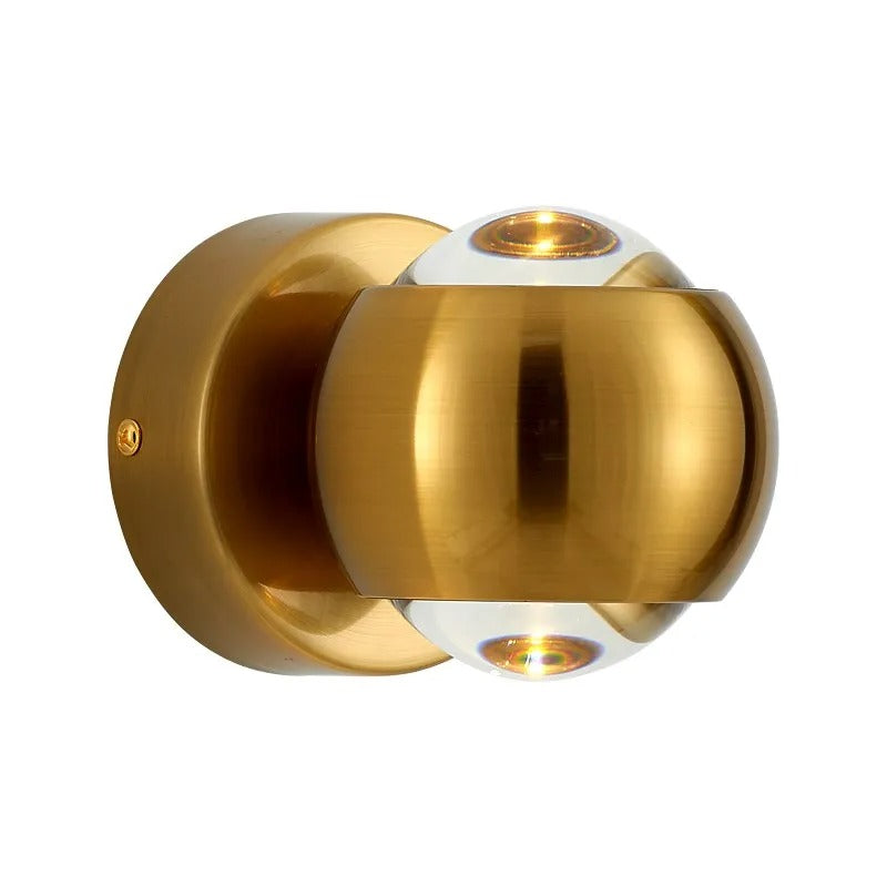 Close view of the gold orb sconce showing the split dome and open ends
