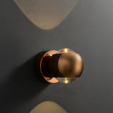 Rose gold orb sconce with height and width measurements marked