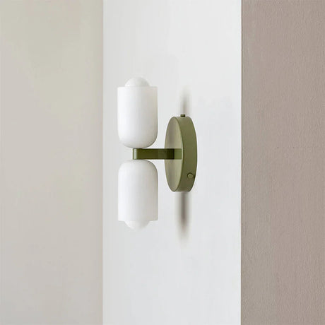 Up and down wall light with an olive green backplate and two white acrylic shades