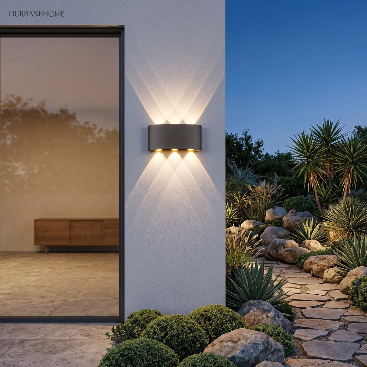 Dark up and down light beside a glazed door lighting a rendered garden wall