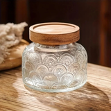 glass storage jars with lids used for food storage on a kitchen table