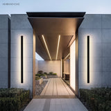 Linear LED wall lights flanking a covered modern entry walkway