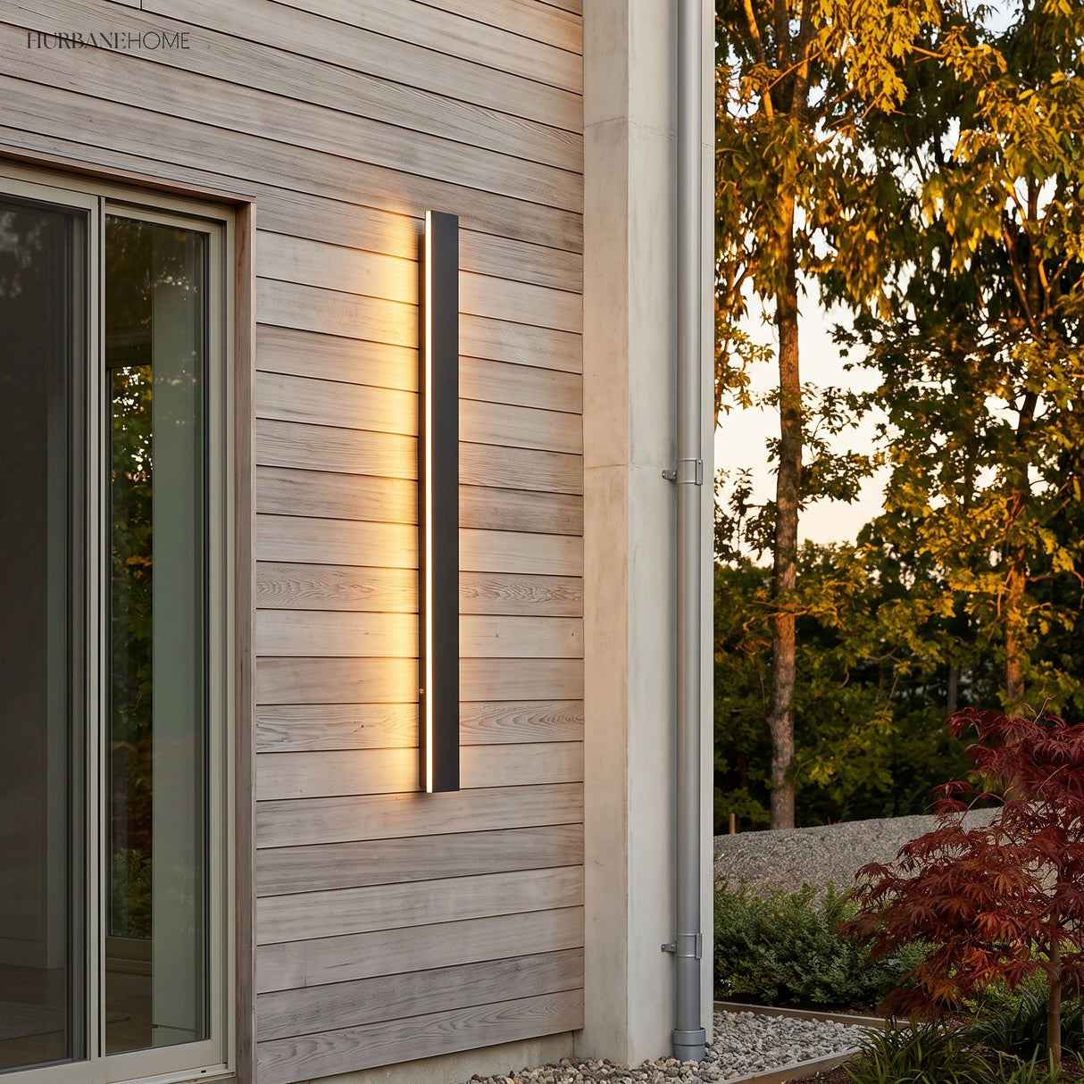 Linear LED wall light on a timber clad exterior wall beside a window