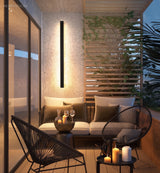 Linear LED wall light above an outdoor patio lounge setting at dusk
