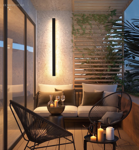 Linear LED wall light above an outdoor patio lounge setting at dusk