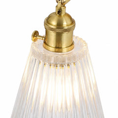 Close up of the knurled brass lamp holder above the ribbed glass