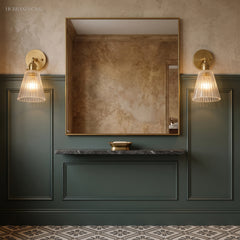 Pair of ribbed glass sconces flanking a mirror above a green vanity