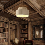 Warm-lit vintage semi flush ceiling light in a dark wood library with globe and bookshelves