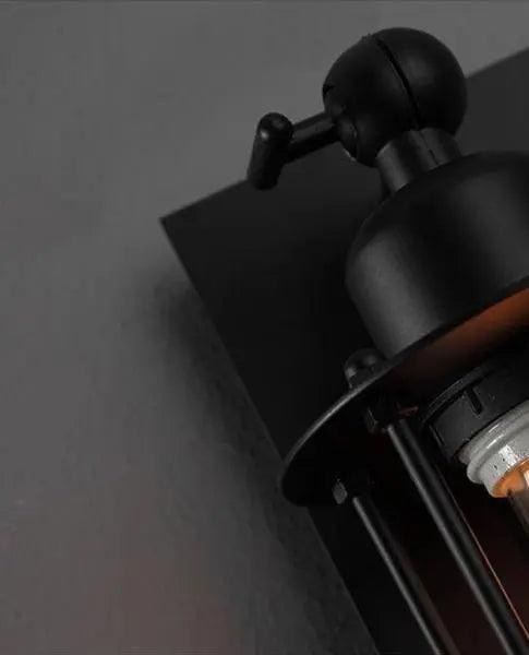 Close view of the lower socket and cage bars of the sconce
