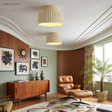 Two cream fluted semi flush ceiling lights lit in a green mid-century living room