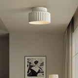 Vintage semi flush ceiling light shown from a low angle against a light backdrop