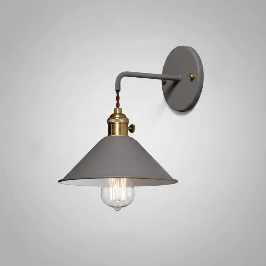 White cone shade sconce with a brass socket on a grey ground