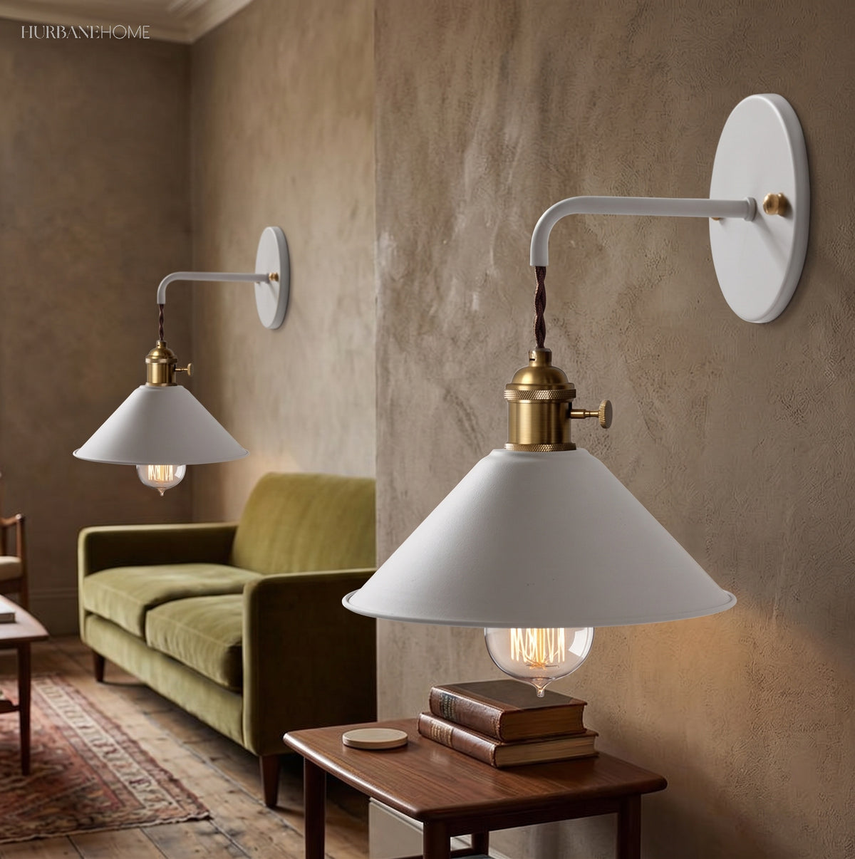 Two white cone shade sconces lit in a room with a green sofa