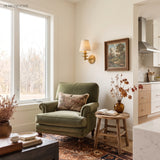 Linen shade sconce above a console table in a panelled hall