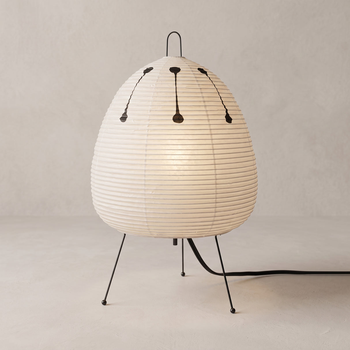Rice paper table lamp with egg shaped shade on wire tripod legs