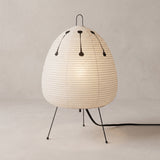 Rice paper table lamp with egg shaped shade on wire tripod legs