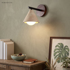 Wabi-sabi wall sconce glowing above a sideboard with books