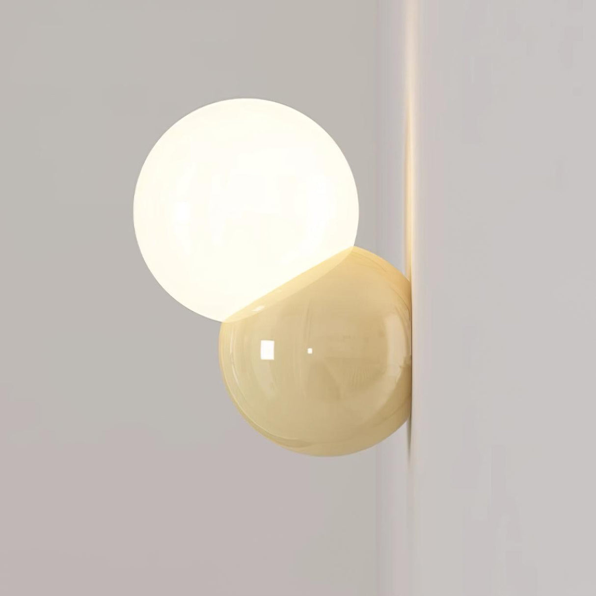 Wall sconce lit close to the corner of two pale walls showing its low profile
