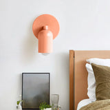 Wall sconce shade rotated upward to wash light across the wall surface