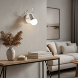White antler sconce shown against a plain pale backdrop