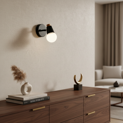 Black sconce without antlers with the shade tilted down