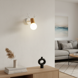 White antler sconce with a wooden shade and exposed bulb