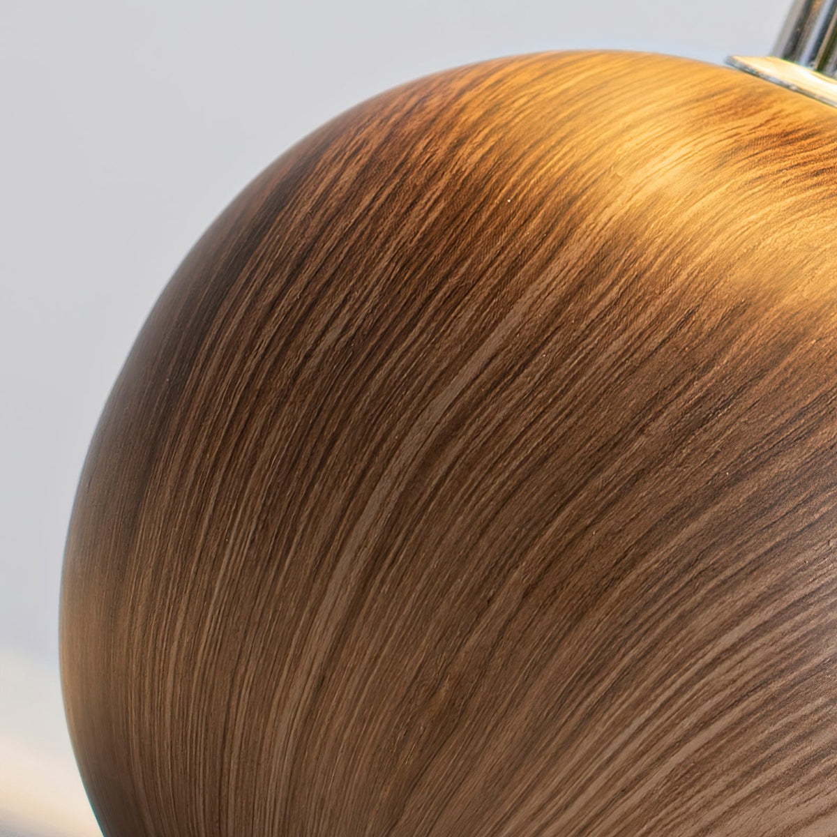 Close up of the turned walnut ball base showing the wood grain