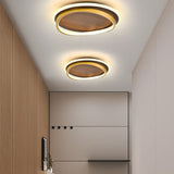 Angled view of the round walnut and gold LED ceiling light