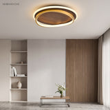 Walnut grain ceiling light lit over a living room with a slatted timber wall