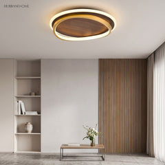 Walnut grain ceiling light lit over a living room with a slatted timber wall