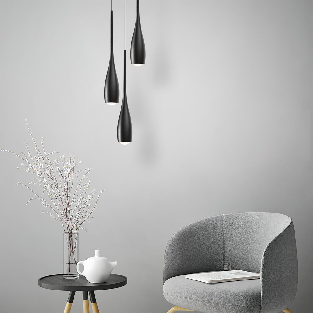 Water drop pendant light hanging over a styled interior setting